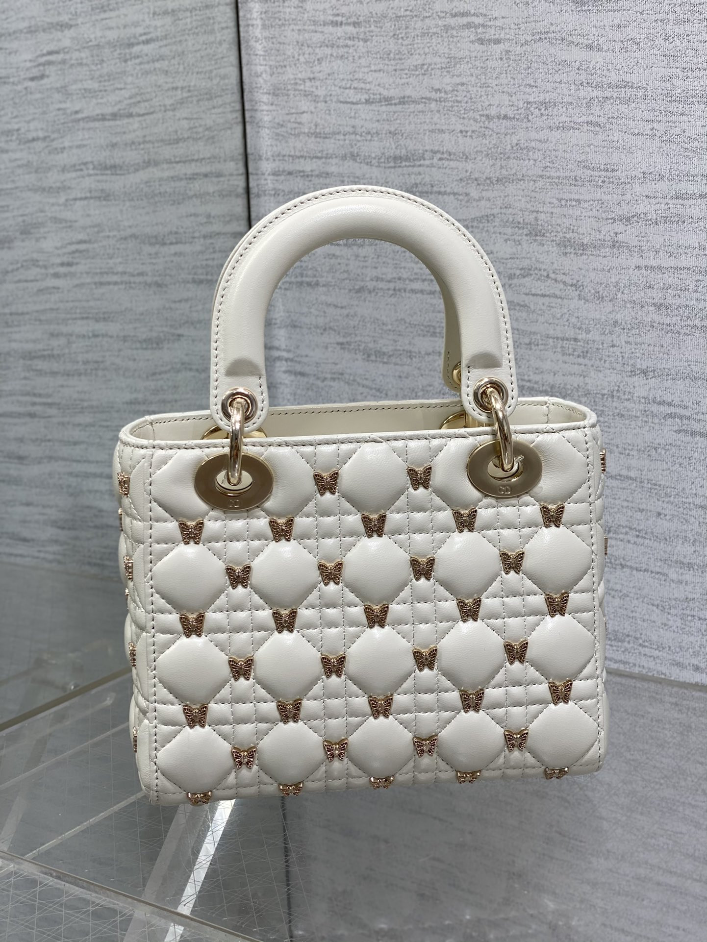 small lady D*or white with butterfly studs