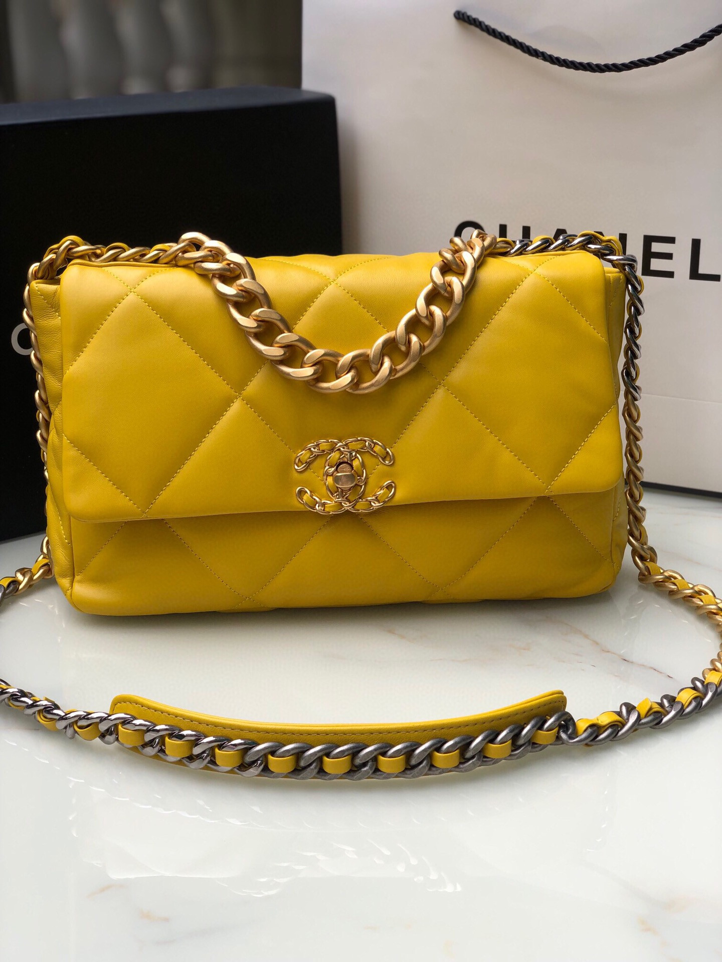Ch*el 19 large handbag shiny leather, gold-tone, silver-tone & ruthenium-finish metal yellow 7.8 × 11.7 × 3.9 in