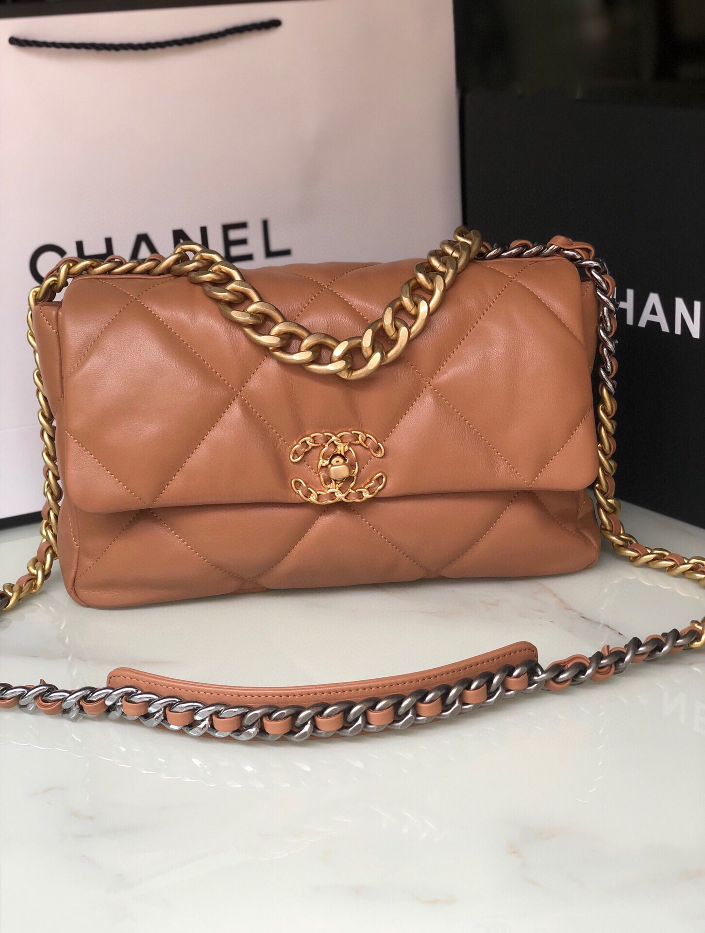 Ch*el 19 large handbag shiny leather, gold-tone, silver-tone & ruthenium-finish metal caramel 7.8 × 11.7 × 3.9 in