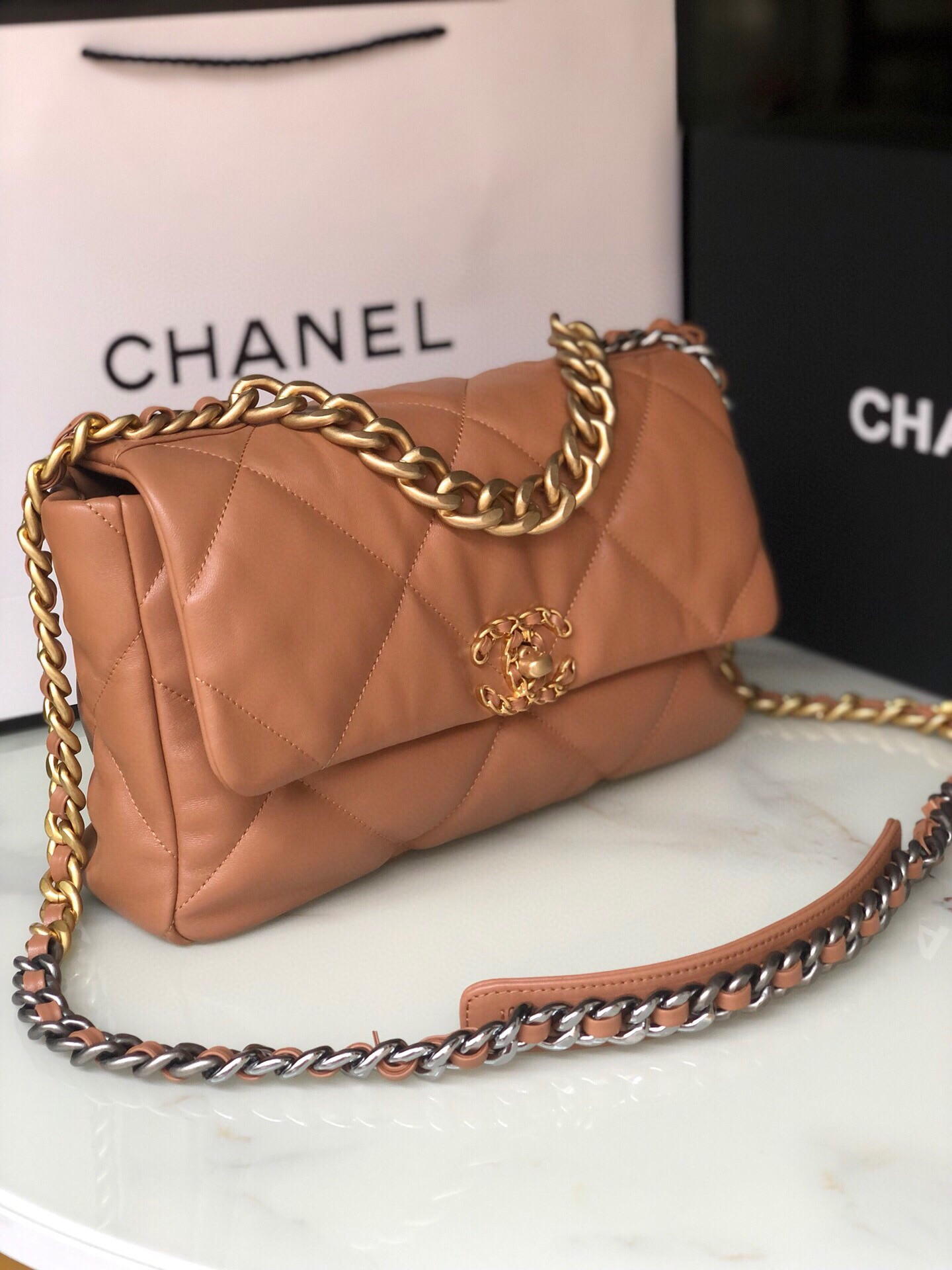 Ch*el 19 large handbag shiny leather, gold-tone, silver-tone & ruthenium-finish metal caramel 7.8 × 11.7 × 3.9 in